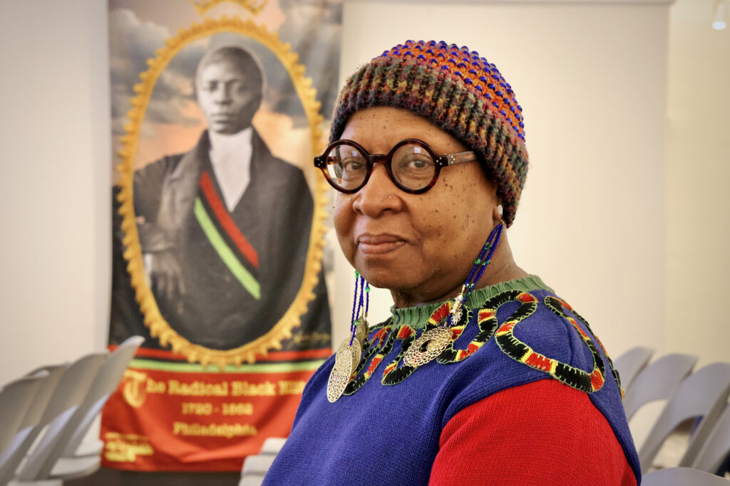 2024 03 13-e lee-xenobia bailey-philadelphia pennsylvania historical society-radical black elite banner Xenobia Bailey poses for a photo