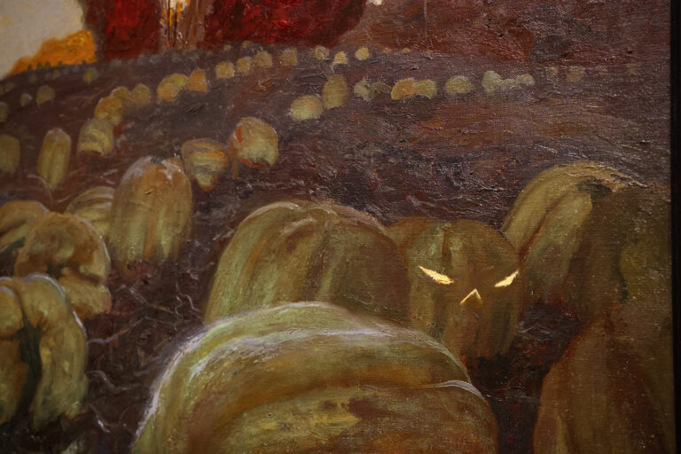 In ''Hill Girt Farm,'' a jack-o-lantern gleams in a field of pumpkins, recording one of Jamie Wyeth's dreams. (Emma Lee/WHYY)