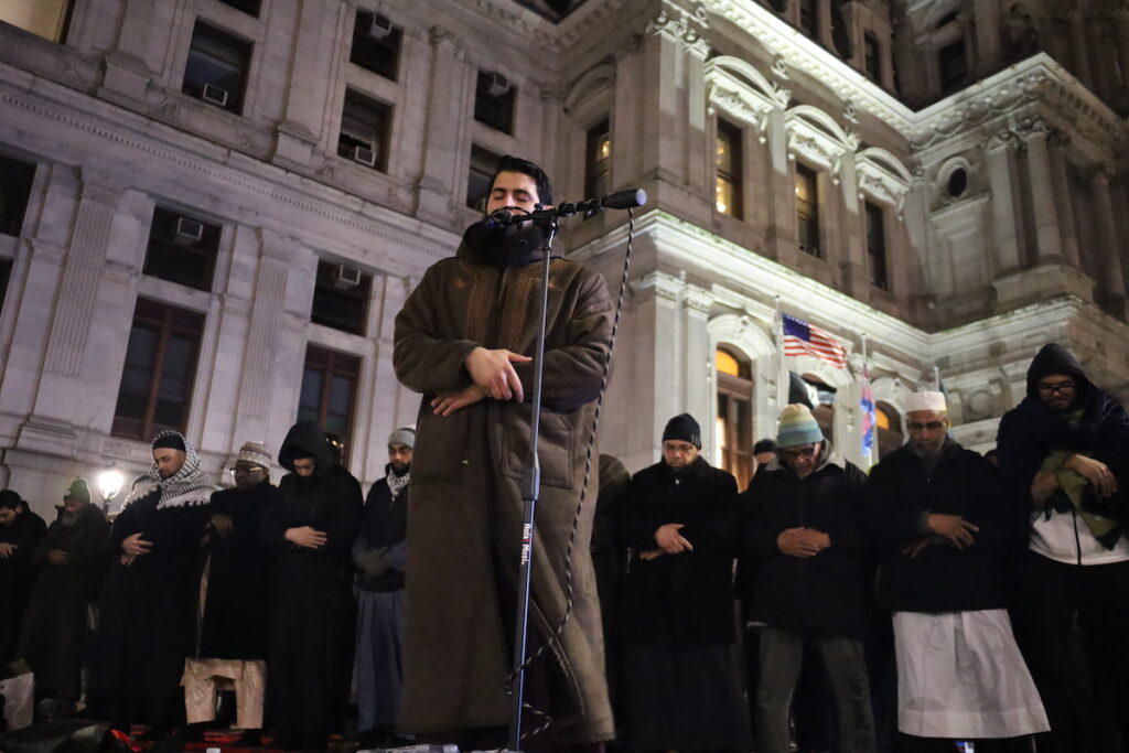 30CRRAMADAN14 Ahmed Burhan, a well-known Quran reciter, leads prayers on Friday outside City Hall as devotees perform rakahs to show their humbleness and devotion. (Carmen Russell-Sluchansky/WHYY)