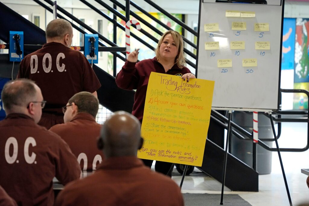 Prison psychological specialist Christine Ransom leads a group session for inmates