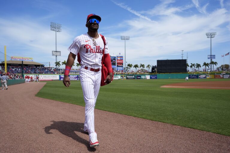 Philadelphia Phillies center fielder Johan Rojas walks on the field before a spring training baseball game against the Atlanta Braves Wednesday, Feb. 28, 2024, in Clearwater, Fla. (AP Photo/Charlie Neibergall)