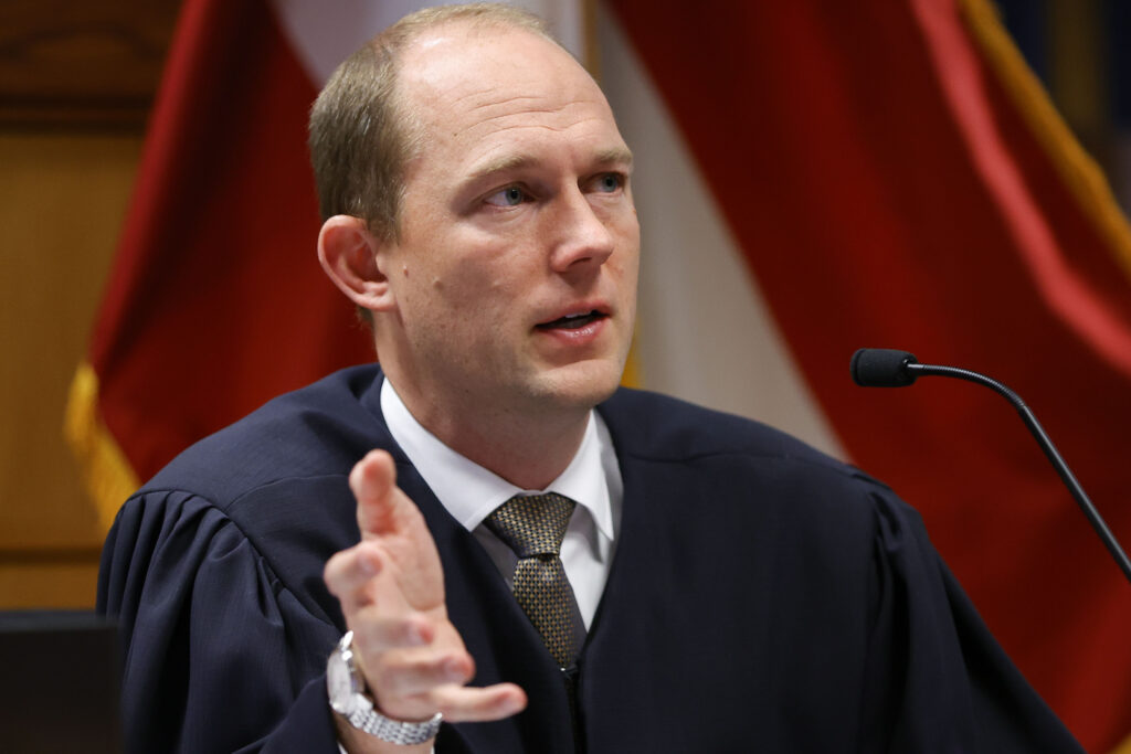 Fulton County Superior Judge Scott McAfee presides in court, Friday, March, 1, 2024, in Atlanta. The hearing is to determine whether Fulton County District Attorney Fani Willis should be removed from the case because of a relationship with Nathan Wade, special prosecutor she hired in the election interference case against former President Donald Trump. (AP Photo/Alex Slitz, Pool)