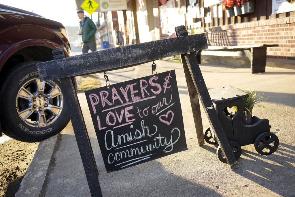 A sign reads Prays and love to the Amish community