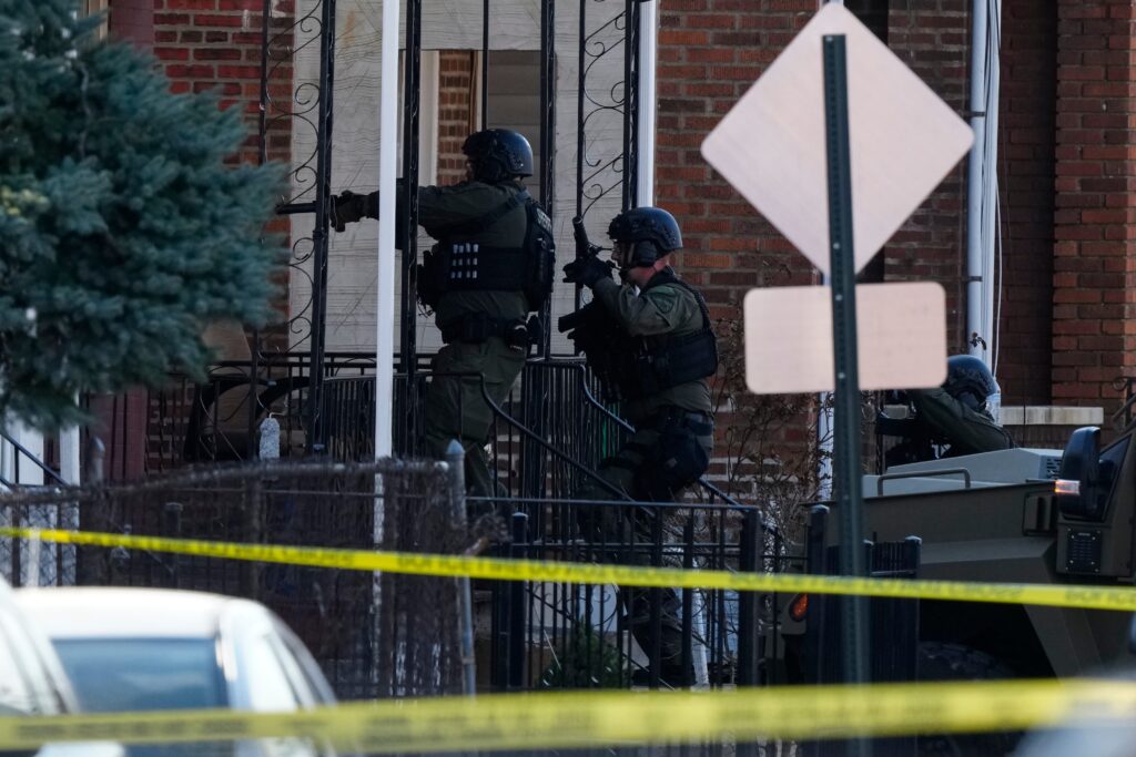 AP24076840724044 (1) Law enforcement officers enter an empty apartment home in Trenton, N.J.