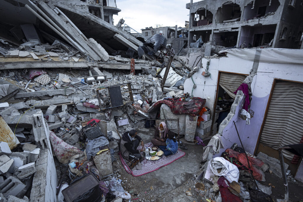 APTOPIX Israel Palestinians Ramadan Members of the Al-Rabaya family break their fast during the Muslim holy month of Ramadan outside their destroyed home by the Israeli airstrikes in Rafah, Gaza Strip, Monday, March 18, 2024.