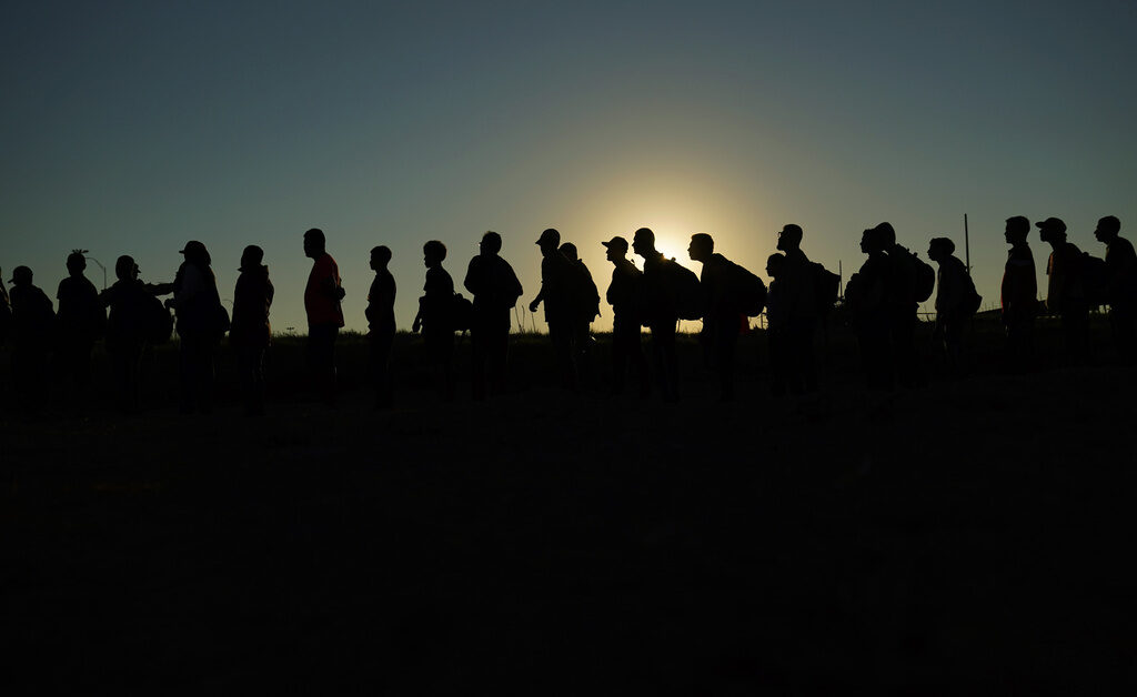 Supreme Court Migrant Arrests Texas FILE - Migrants who crossed the Rio Grande and entered the U.S. from Mexico are lined up for processing by U.S. Customs and Border Protection, Sept. 23, 2023, in Eagle Pass, Texas. A divided Supreme Court on Tuesday, March 19, 2024, lifted a stay on a Texas law that gives police broad powers to arrest migrants suspected of crossing the border illegally, while a legal battle over immigration authority plays out. (AP Photo/Eric Gay, File)