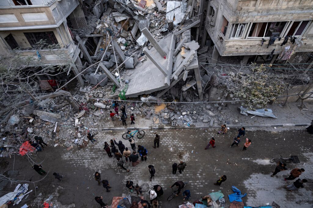 Palestinians inspect the damage of residential buildings