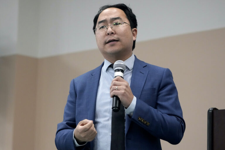 Andy Kim speaking into a microphone