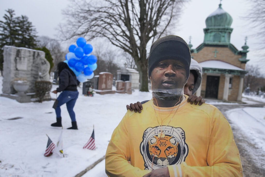 Lethal Restraint Race Timere Jones, right, carries a life-sized picture of his brother, Jameek Lowery