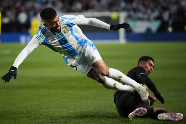 Argentina's Nicolas Gonzalez, left, collides with El Salvador's Melvin Cruz during the first half of a friendly soccer match