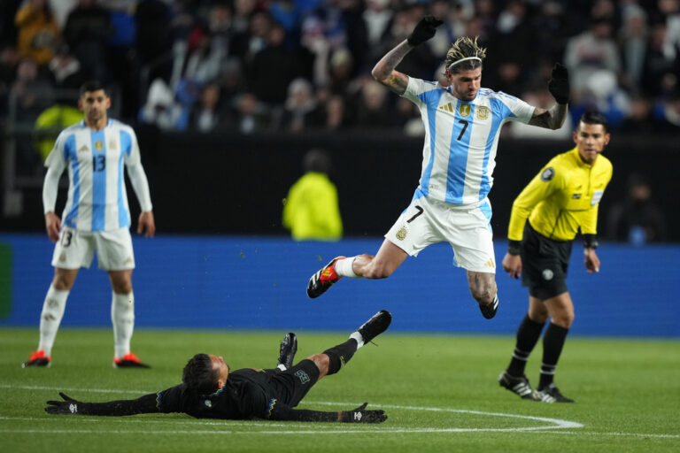Argentina's Rodrigo De Paul, right, collides with El Salvador's Narciso Orellana during the first half of a friendly soccer match