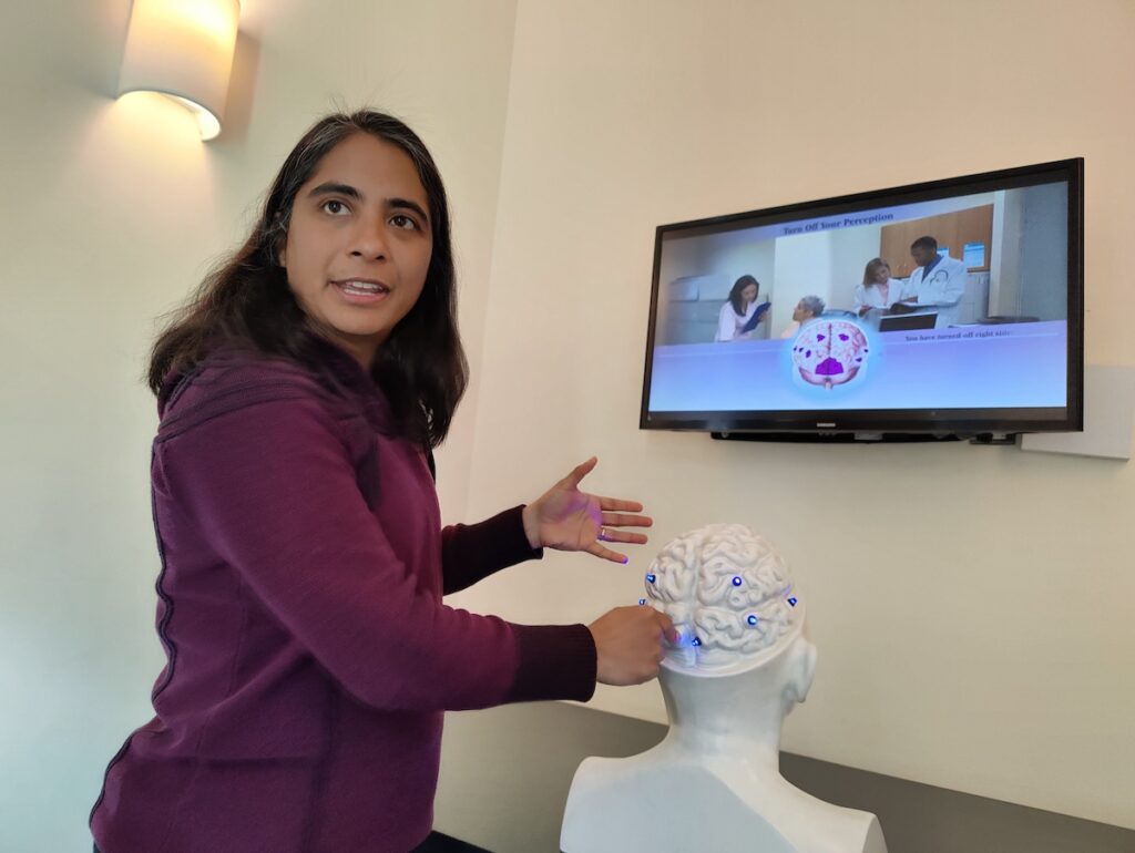 Jayatri Das, chief bioscientist of the Franklin Institute, gestures towards a model of the brain