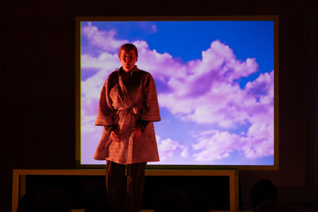 art-series-connect-3 A performer stands in front of a screen with clouds