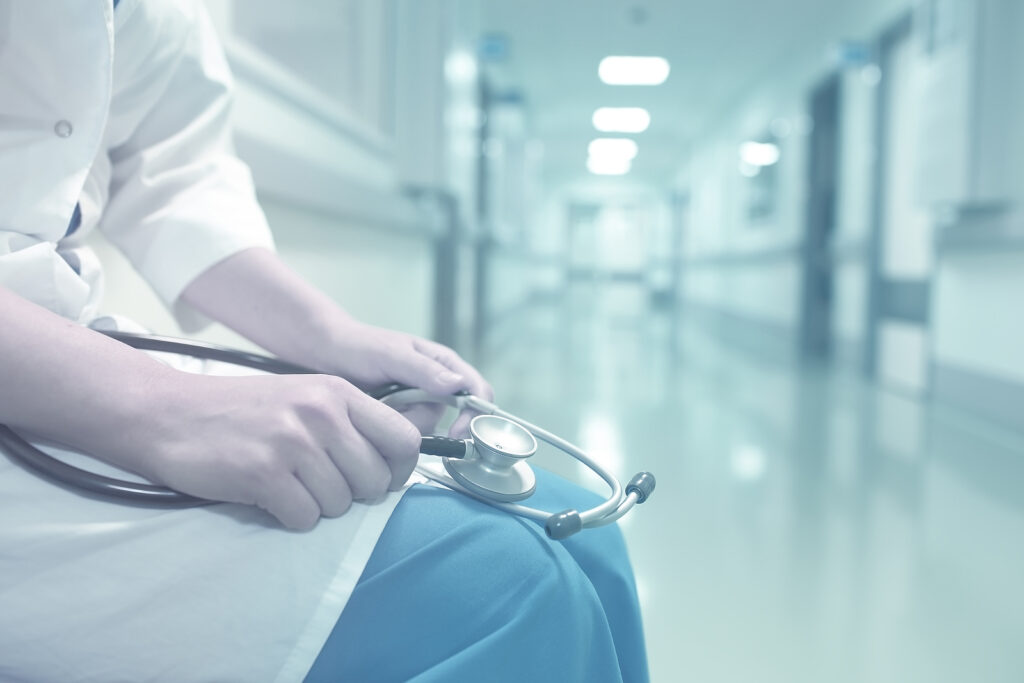 Doctor in empty hospital corridor