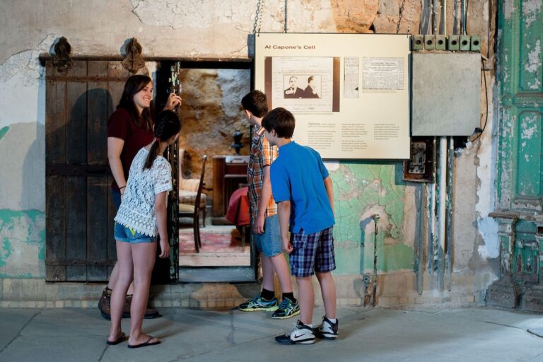 People look into a former cell space at Eastern State Penitentiary Historic Site