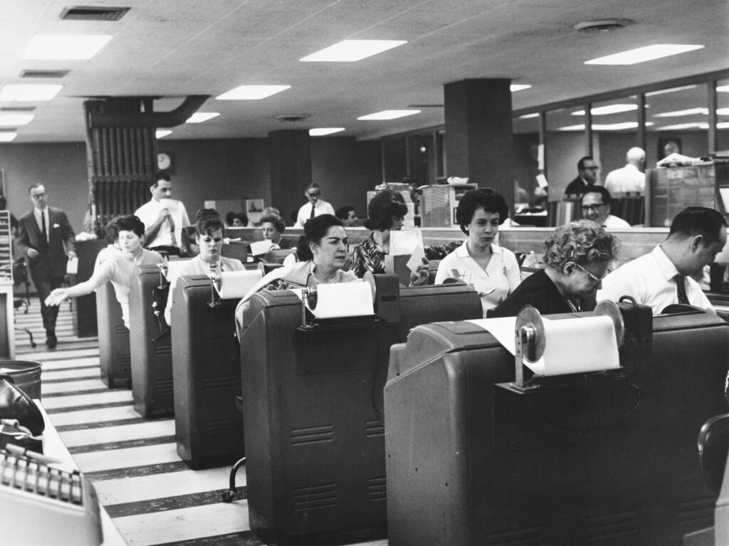 gettyimages-1492197659-28e0faba1279b48fc4f88d794a72f875ebd4a14b-s1600-c85 Employees of Goodbody & Co. work at the stock brokerage's headquarters in Manhattan, N.Y., circa 1965.
