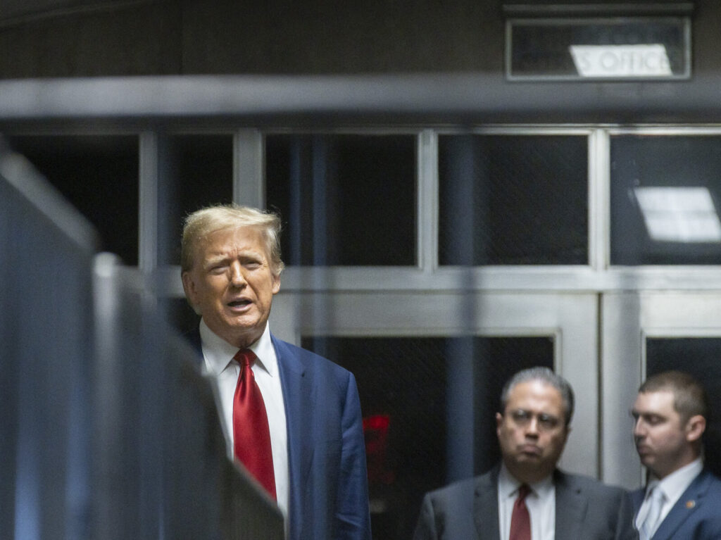 US-POLITICS-JUSTICE-TRUMP Former US President Donald Trump speaks to the press in a hallway outside the courtroom at the end of a hearing to determine the date of his trial for allegedly covering up hush money payments linked to extramarital affairs, at Manhattan Criminal Court in New York City on March 25, 2024. Trump faces twin legal crises today in New York, where he could see the possible seizure of his storied properties over a massive fine as he separately fights to delay a criminal trial even further. (Photo by JUSTIN LANE / POOL / AFP) (Photo by JUSTIN LANE/POOL/AFP via Getty Images)