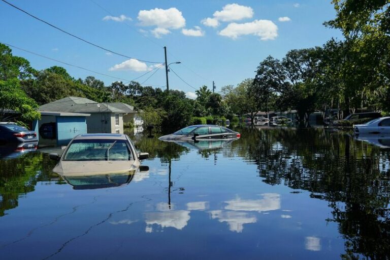 Flooded street with cars under water