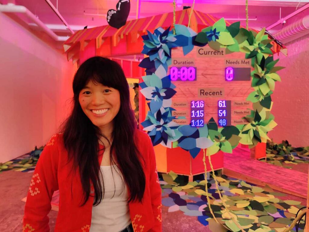 group-hug-3 Artist Risa Puno on the floor of her Whac-a-Mole game, in her installation