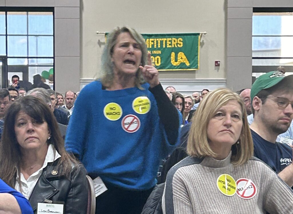 Maya van Rossum yelling from the crowd at the meeting