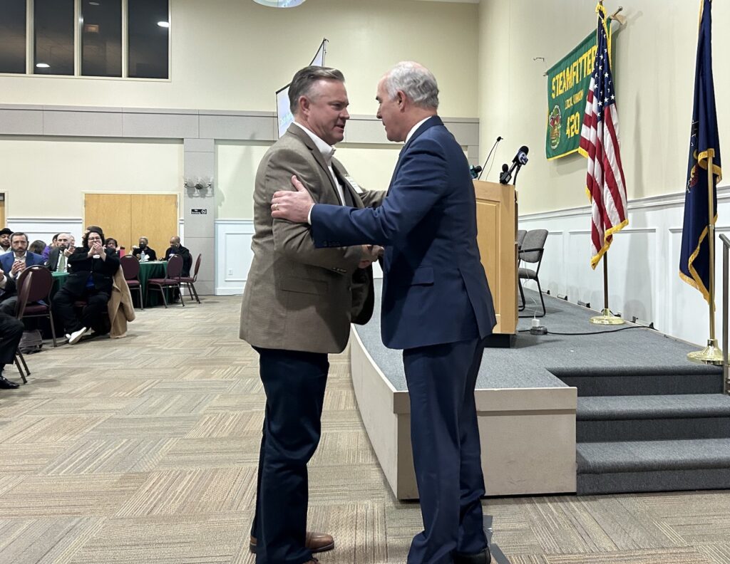 Bob Casey and Jim Snell greeting each other