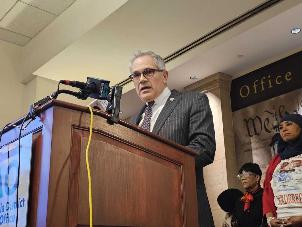 Krasner speaks at a podium