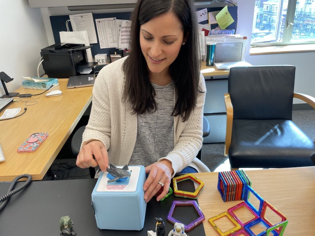 Erica Bess displays a learning device that's part of the library of things part of the library