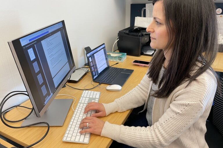 Erica Bess types while looking at a computer screen