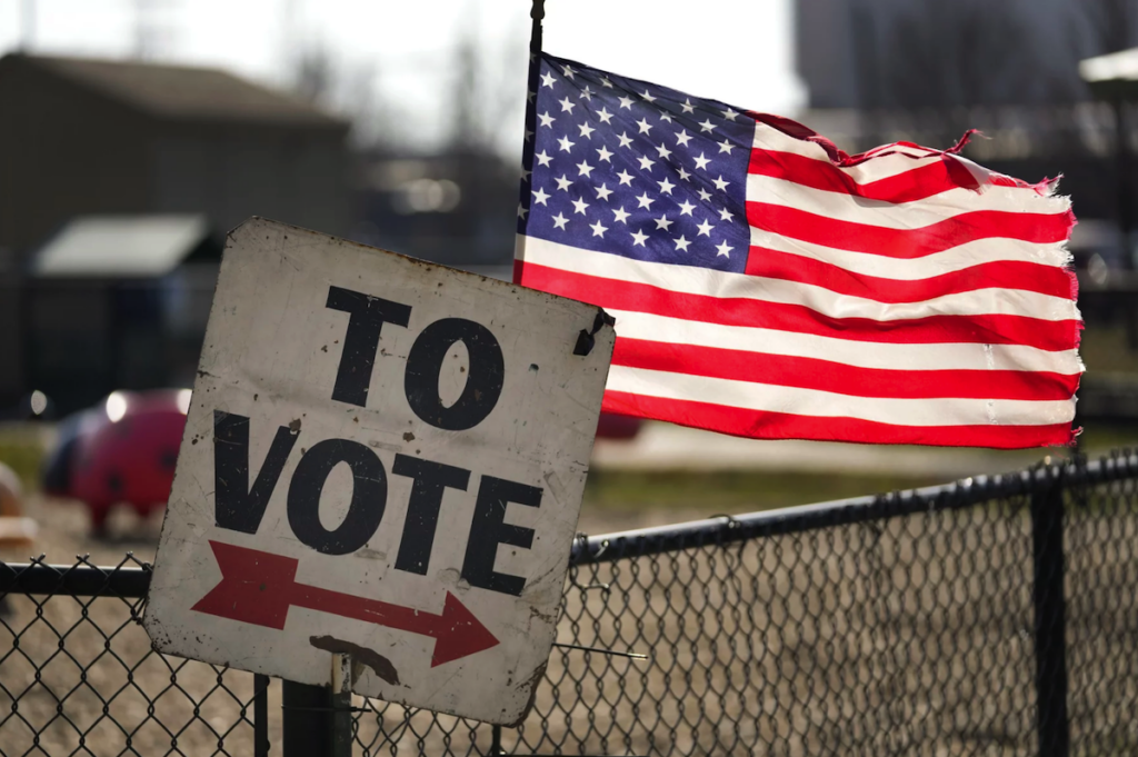 A sign says ''To vote,'' followed by an arrow