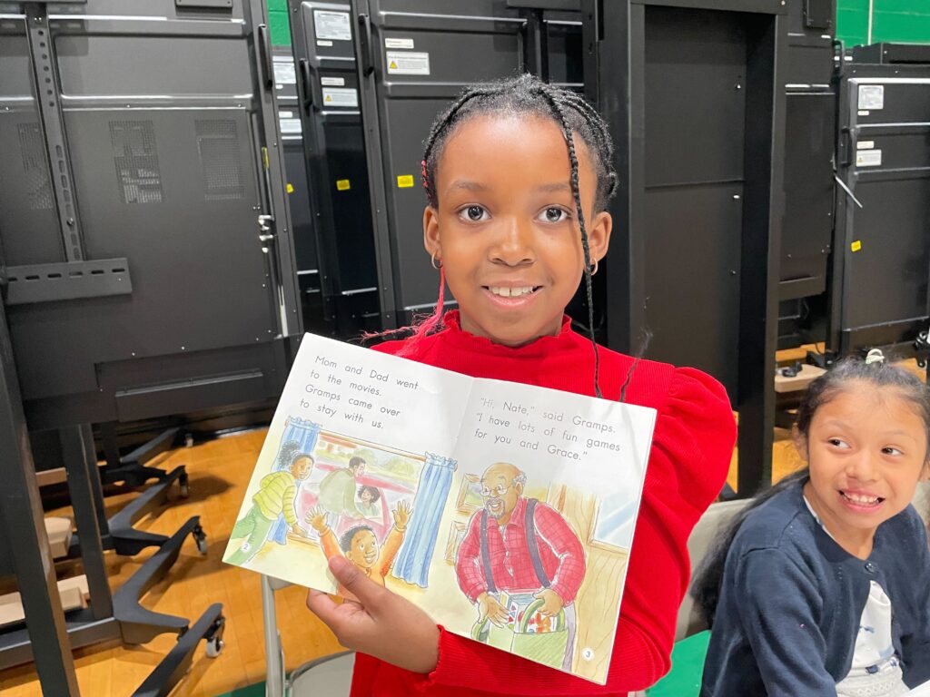schools-reading-d-matthau-2024-03-27-5 A young girl holding up her favorite book