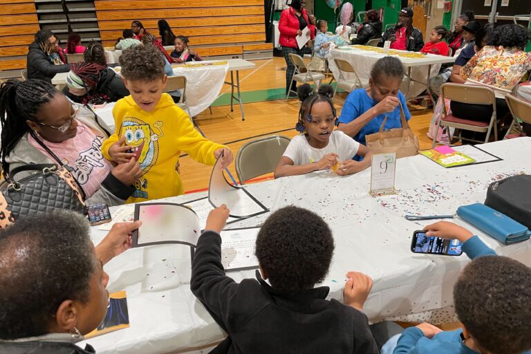 Children sitting at a table with their parents