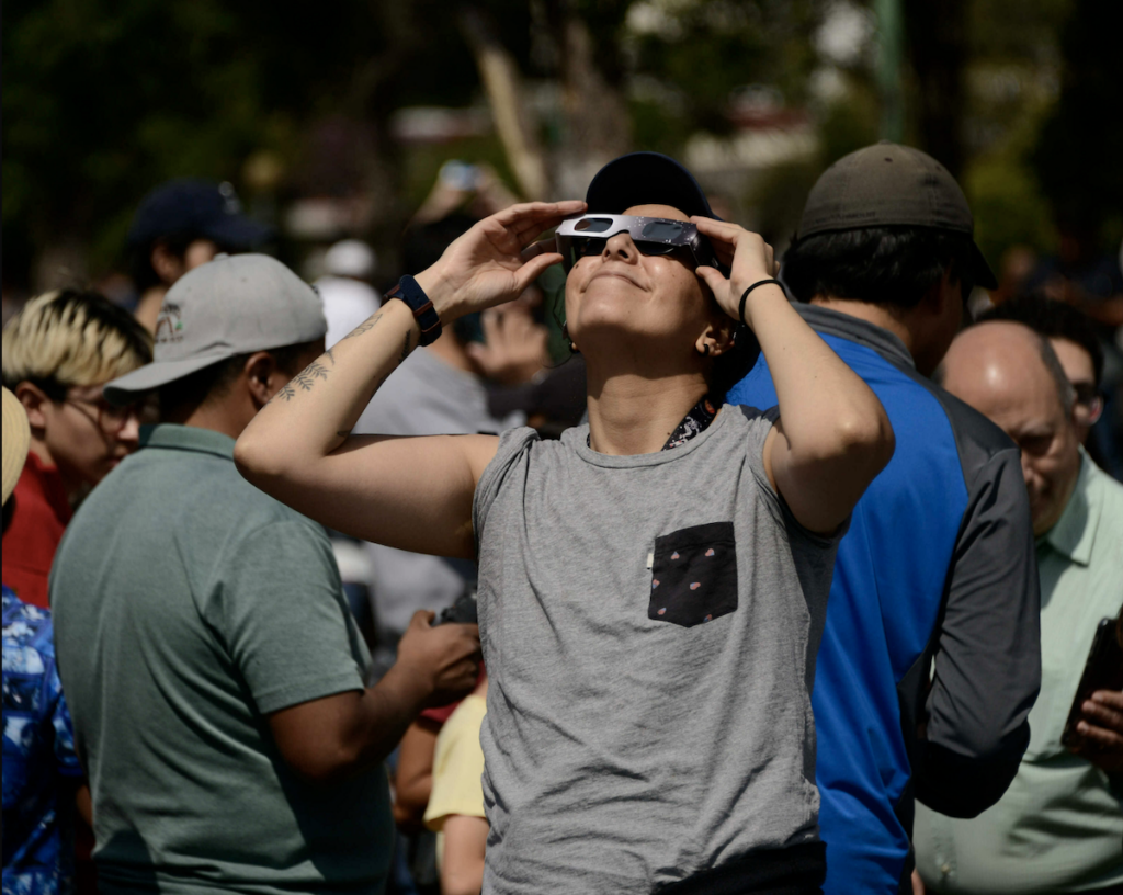 solar-eclipse-glasses-getty A woman watches an annular solar eclipse on Oct. 14, 2023 using special solar filter glasses at the National Autonomous University of Mexico.