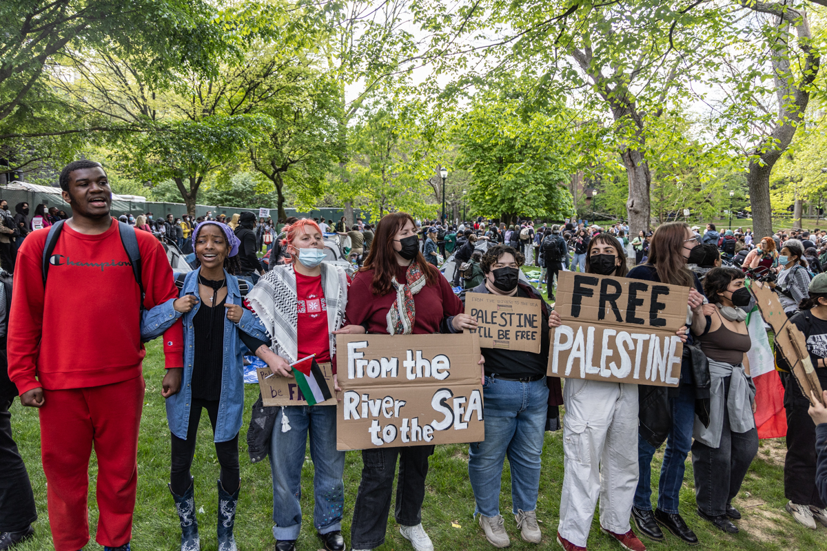 Students protesters linked arms to protect others pitching tents on the campus of the University of Pennsylvania after a march and rally calling for the school to disclose its investors and to stop silencing students on April 25, 2024. (Kimberly Paynter/WHYY)