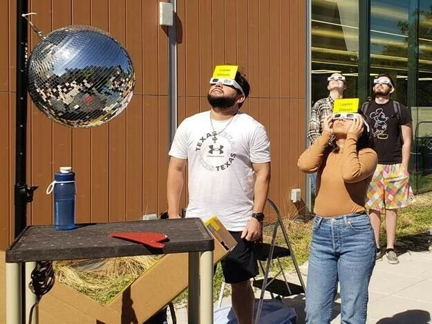 Two people wearing eclipse glasses