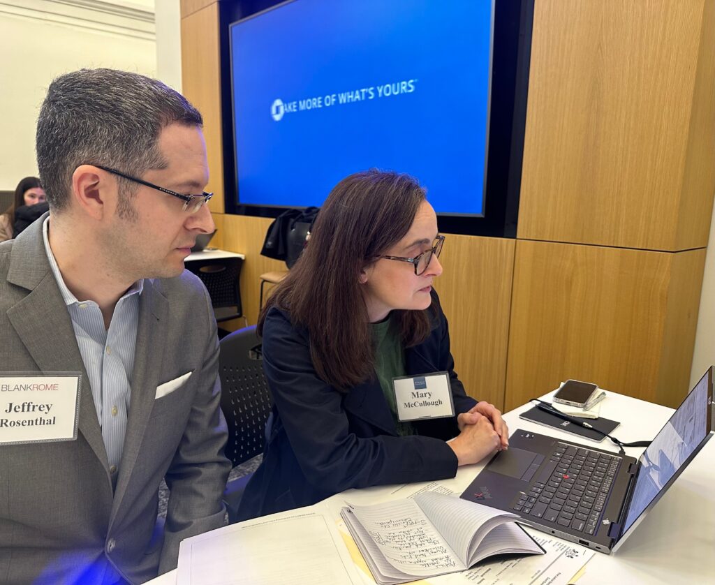 Pro-bono attorneys Jeff Rosenthal, partner at Blank Rome and JPMorgan Chase's Mary McCullough work together on a pardon in West Philadelphia. (Kristen Mosbrucker-Garza/WHYY)