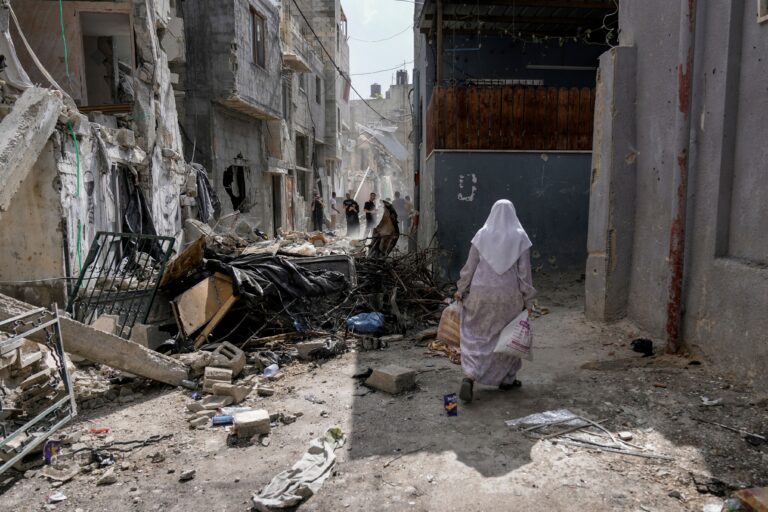 Palestinians inspect the destruction following an Israeli military raid in Nur Shams refugee camp