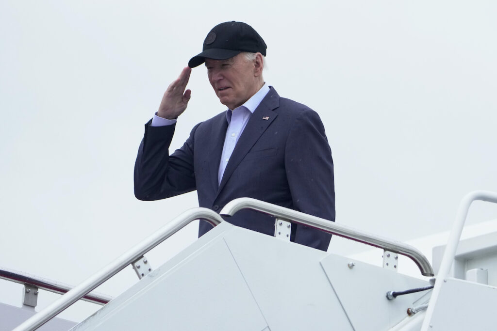 President Joe Biden salutes as he boards Air Force One