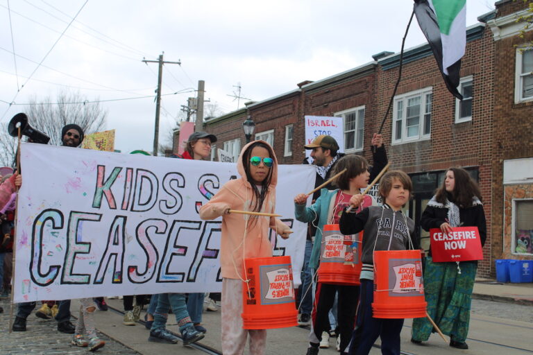 people marching in the street for a ceasefire