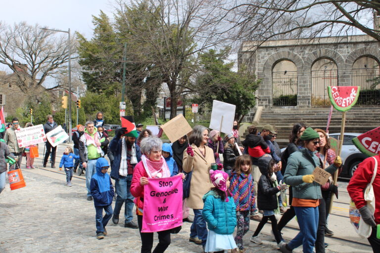 people marching in the street for a ceasefire