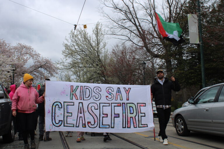 people marching in the street for a ceasefire