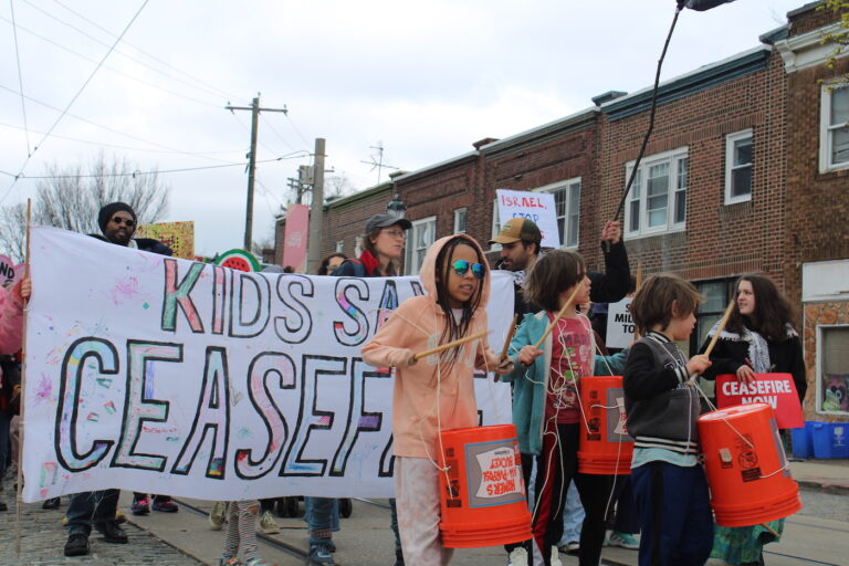 people marching in the street for a ceasefire