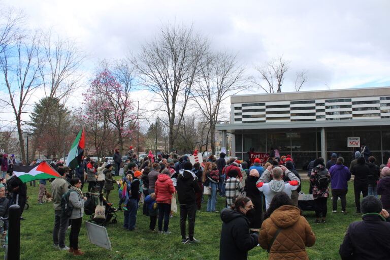 People listening to speakers at the rally