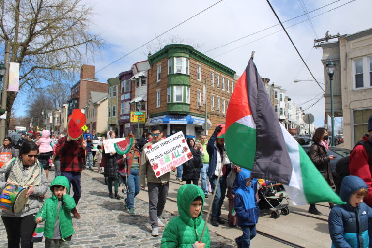 people marching in the street for a ceasefire