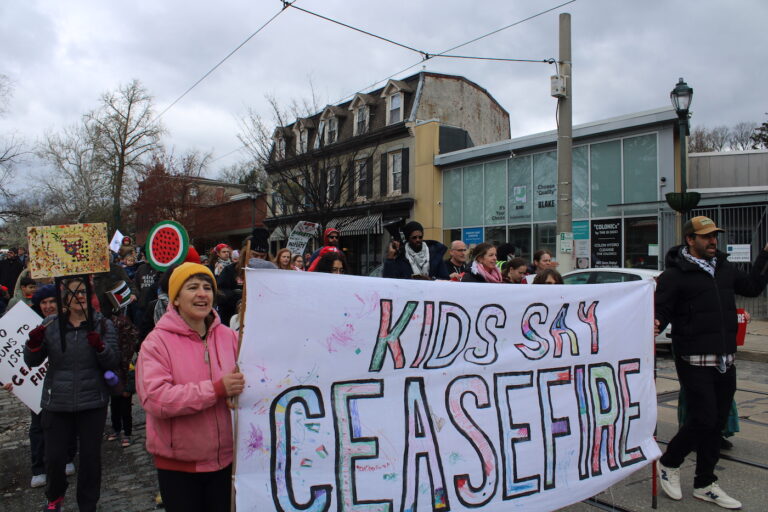 people marching in the street for a ceasefire
