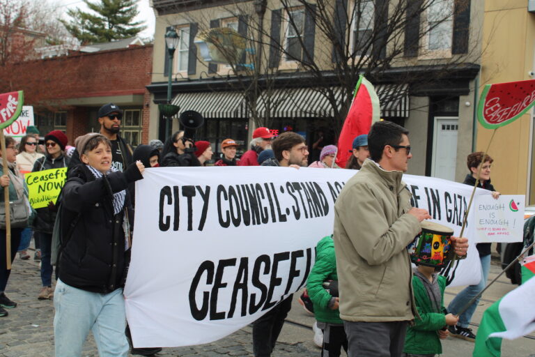 people marching in the street for a ceasefire