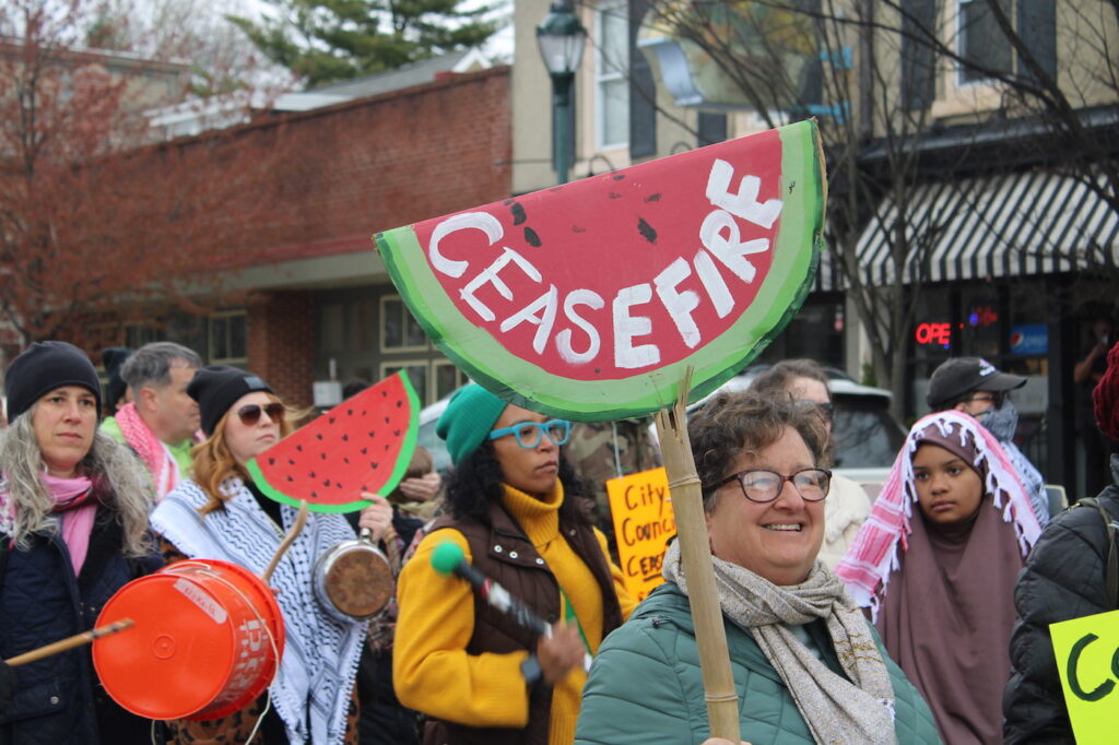 people marching in the street for a ceasefire