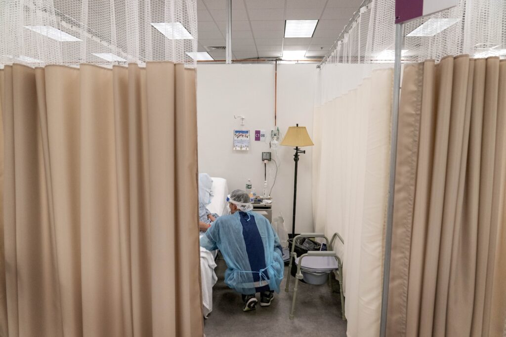 health-care-doctor-nurse-medicaid-AP-040324.jpg A physical therapist works with a patient at a field hospital.