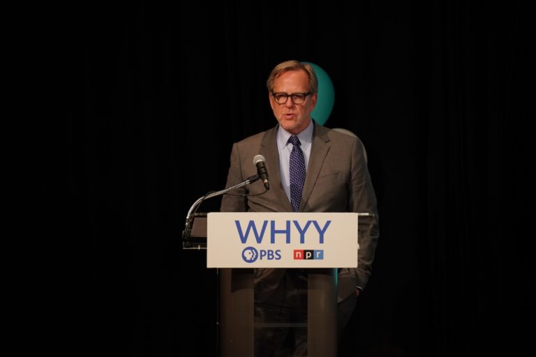 John F. Salveson speaks from a podium