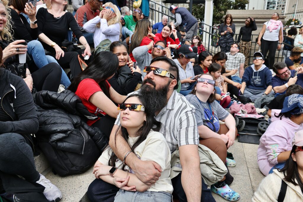 solar-eclipse-philadelphia-franklin-institute-multiple-people-040824 Eclipse viewers on the steps of the Franklin Institute