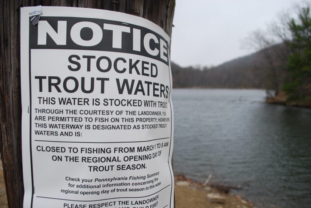 A notice sign claiming water has been filled with trout